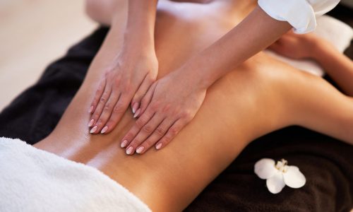Relaxed smiling woman receiving a back massage in a spa