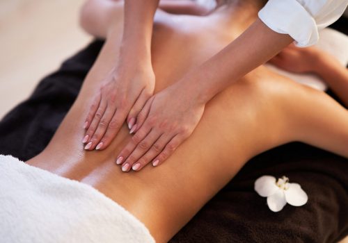 Relaxed smiling woman receiving a back massage in a spa